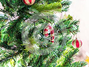 Closeup ornaments on Christmas tree, holiday background concept with balls and candy cane