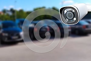 Closeup outdoor CCTV camera at a car parking lot.