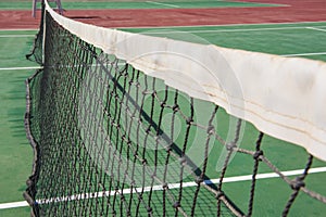 Closeup of outdoor clay tennis court with net