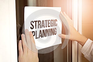 Closeup of owner holding text Strategic Planning in store