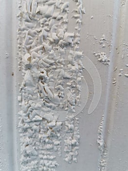 Closeup paint blistering on wood painting door.