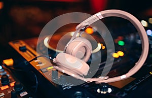 Closeup pair of headphones for DJ.cd mp4 music deejay mixing desk music party in nightclub. Club console for experiments with