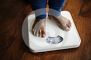 Closeup of a pair of leg measuring on weigh scale photo