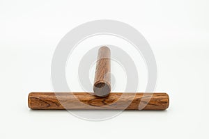 A pair of wooden claves lying on a white underground photo