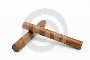 A pair of wooden claves lying on a white underground photo