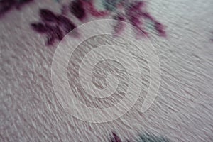 Closeup of pale napped fabric in shades of pink