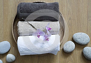 Closeup of pampering towels and zen stones for female bodycare