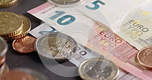 Closeup panning over Euro coins to five, ten and twenty Euro Banknotes, Money from Europe with safety features