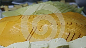Closeup panorama at assortment with different types of cheese slices