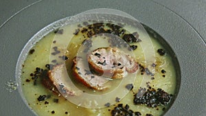 Closeup panorama on onion cream soup decorated with homemade sausage slices