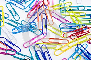 Closeup paperclips in different color on white background