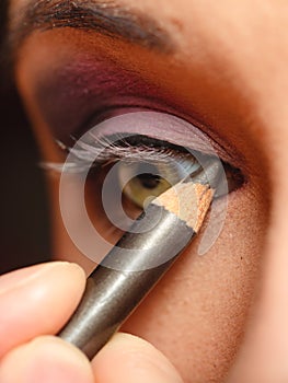 Closeup part of woman face eye makeup detail.