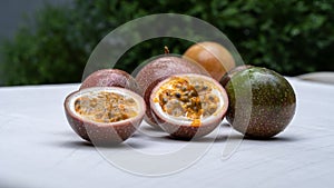 Closeup passion fruit with slices isolated on gray blurred background.Fruits or healthcare concept.