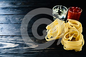 Closeup pasta and tomato sauce black wood