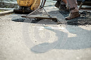 Closeup of patching a bump in the road
