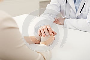Closeup of patient and doctor hands photo