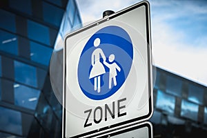 Closeup of a pedestrian zone sign in the street of a modern district photo