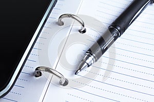 Pen, notebook and cell phone