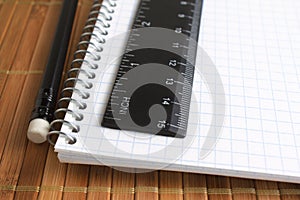 Pencil, spiral notebook and ruler