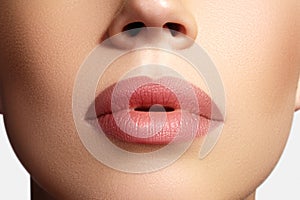 Closeup perfect natural lip makeup. Beautiful plump full lips on female face. Clean skin, fresh make-up. Spa tender lips