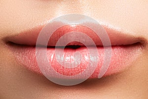 Closeup perfect natural lip makeup. Beautiful plump full lips on female face. Clean skin, fresh make-up. Spa tender lips