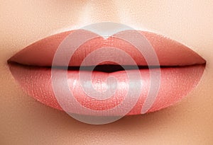 Closeup perfect natural lip makeup. Beautiful plump full lips on female face. Clean skin, fresh make-up. Spa tender lips