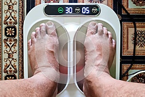 Closeup of person feet receiving magnetic therapy from electricity powered geomagnetic device, promising general well