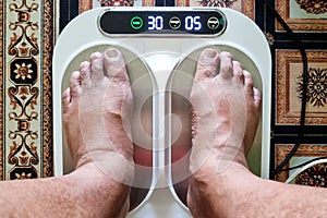 Closeup of person feet receiving magnetic therapy from electricity powered geomagnetic device, promising general well photo