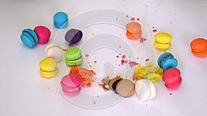 Closeup of a person hand smashing and beating colorful macaron (macaroon) dessert food and destroy crush it with anger into little