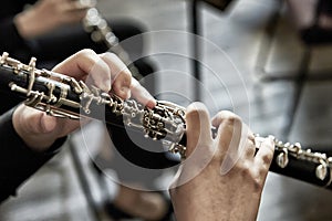 Closeup of a person playing the oboe, indoors