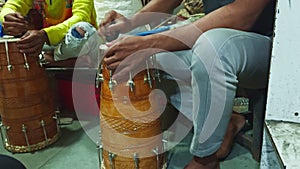 Closeup of a person playing a traditional drum with hands cultural music concept man repairing drum at musical workshop