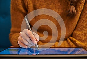 Closeup of a person writing on a tablet. Close up of a person working on a tablet. Woman working on a convertible