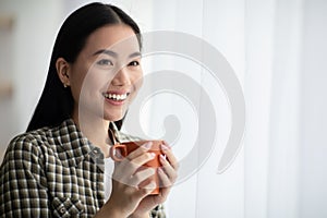 Closeup of pertty asian lady looking through window