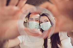 Closeup photo of adorable young couple lady guy spend quarantine together stay home happy making arms fingers heart sign