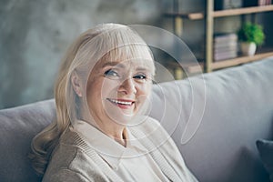 Closeup photo of amazing adorable aged granny homey good mood toothy beaming smiling sitting comfort sofa divan living