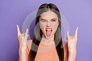 Closeup photo of attractive crazy funky lady long brown straight hairstyle show finger horns sticking tongue wear casual