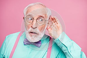 Closeup photo of attractive grandpa hand near ear listen rumors focused chatterbox bad person wear specs mint shirt