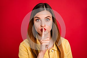 Closeup photo of attractive lady hold finger on lips say secret best friend chatterbox person sly eyes wear casual