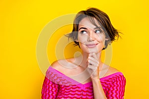 Closeup photo of attractive pretty youngster lady wear pink knitted shirt touch chin minded look empty space hmm