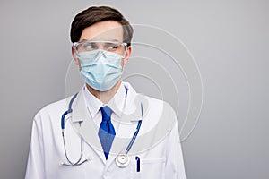 Closeup photo of attractive serious virologist doc guy professional surgeon listen patient wear facial protective mask