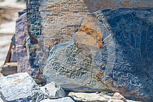 Closeup Photo Autentic Draw Stone Buddist Symbols and Mantras. Horizontal. Nepal Travel Trakking.