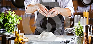 Closeup photo of baker cracking egg for dough. Retro styled imagery