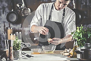 Closeup photo of baker cracking egg for dough. Retro styled imagery