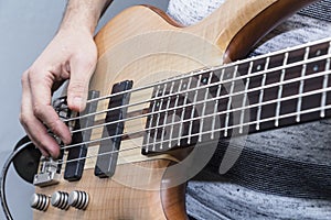 Closeup photo of bass guitar player hands, soft selective focus, live music theme