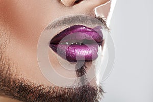 Closeup photo of bearded male lips with makeup