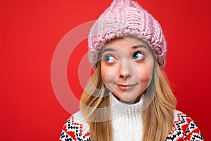 Closeup photo of beautiful thoughtful dreaming positive young blonde woman standing isolated over colourful background