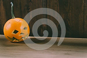 Closeup Photo of Carved Baby Pumpkin on the Wodden Background