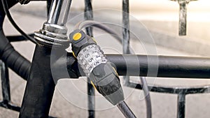 Closeup photo of combintaion lock on old black bicycle