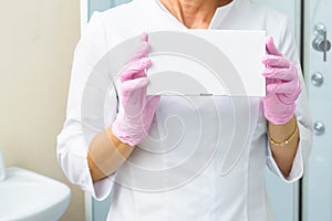 Closeup photo of cosmetologist`s hands holding white box with fillers. Health care, Medical and Pharmacy Concept. Mock up for you