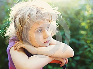 Closeup photo of a dreaming little girl outdoor